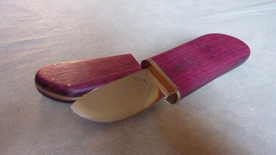 Small knife forged XC75, water quenching. Handle and scabbard amaranth, leather and brass spacers.