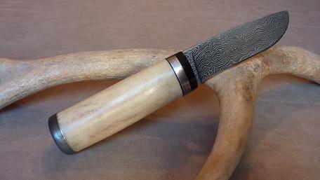 Damascus knife 15N20/o2, quenching oil, antler handle, steel and brass spacers, buffalo horn guard .